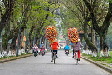 Woman selling flowers made of colored paper. Flowers made of colored paper, in the Thanh Tien...