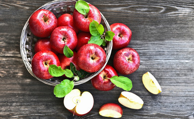 a lot of Red apples or Gala apples with fresh leaf  on wooden background.