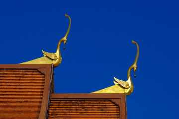 Thai style architecture, roof of temple in Thailand on sky background.