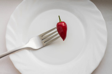 
red hot pepper on a fork