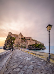 Naples, Italy 2017 dawn at Aragonese Castle Romantic medieval castle on a islet joined to Ischia by a stone bridge, plus tours & tunnel access.
 - obrazy, fototapety, plakaty