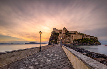 Naples, Italy 2017 dawn at Aragonese Castle Romantic medieval castle on a islet joined to Ischia by...