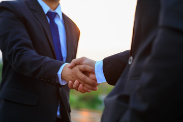Closeup shot of two businessmen shaking hands outdoor. Handshake, Business, Agreement, Partnership - Teamwork, Mergers and Acquisitions concepts