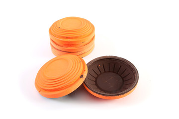 Orange cymbals for trap shooting on white background
