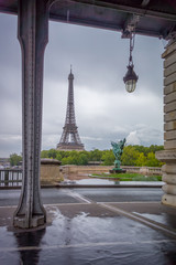 Fototapeta na wymiar Paris, France - Eiffel Tower view from a Parisian corner, beautiful scenery in the rainy afternoon 
