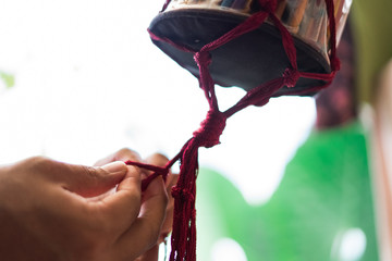 Hand of a craftsman knitting handmade macrame.