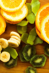Slices of orange, banana, kiwi and peel kiwi, top view