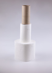 The unused white tissue roll was taken in a studio shot on a white background, with detailed details on the surface, the waves and perforations looking soft and providing comfort to users.