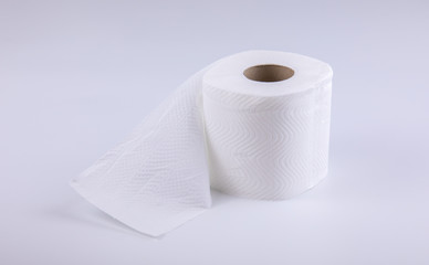 The unused white tissue roll was taken in a studio shot on a white background, with detailed details on the surface, the waves and perforations looking soft and providing comfort to users.