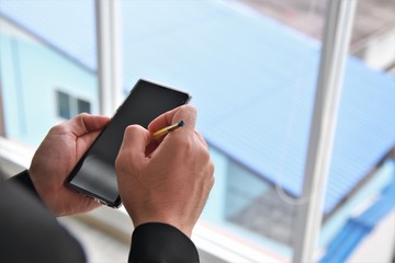 Work from home concept close up hand using mobile phone VPN to office business avoid Covid-19 Coronavirus