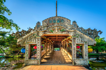 Wonderful view of the "Cau Ngoi Thanh Toan " or Thanh Toan tile bridge near Imperial City with the Purple Forbidden City within the Citadel in Hue, Vietnam. 