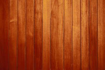 Vertical wooden planks. Dark brown background.