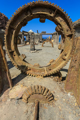 Huge rusty gearwheels in the ruins of an old sulfur processing plant on White Island, New Zealand