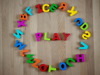Colorful alphabet blocks forming word - Play