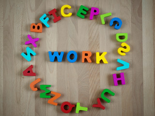 Colorful alphabet blocks forming word - Work