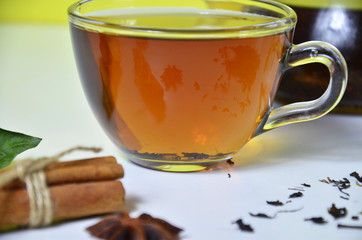 Glass Cup Tea with with cinnamon and anise on White Background.
