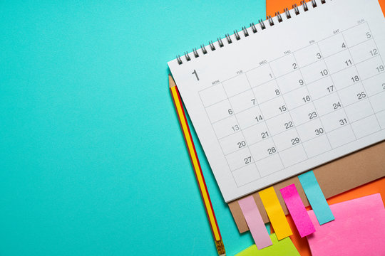 close up of calendar on the green table background, planning for business meeting or travel planning concept