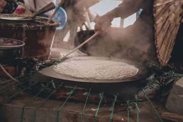 Traditional Banh Trang or rice paper making in Nhon Hoa rice paper village in Mekong Delat Vietnam that is both a livelihood and cultural tourist attraction