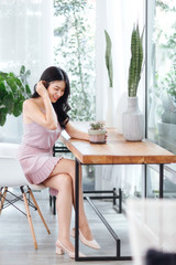 Beautiful Asian woman wear dress pants pink. Sitting on chair and white background.