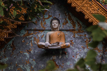 Cinematic photo of an old buddha sculpture in khmer style on an abandoned temple in Bokor Mountains in Kampot Province, Cambodia