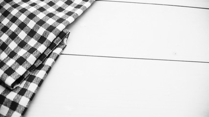 Wooden table covered with tablecloth cloth checkered