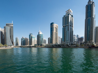 Fototapeta na wymiar February 2020: Dubai Marina skyscrapers, port with luxury yachts and Marina promenade, Dubai, United Arab Emirates