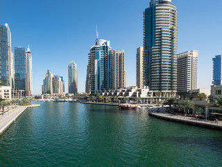 February 2020: Dubai Marina skyscrapers, port with luxury yachts and Marina promenade, Dubai, United Arab Emirates