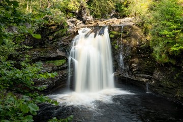 Fototapeta na wymiar Falls of Falloch in Scotland, Great Britain where people like to jump into water