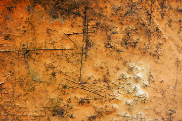 Metallic texture background yellow. Cracks, scratches and abrasions on the iron surface. Piece of plywood
