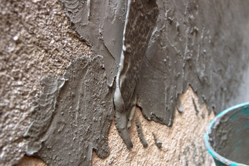 spatula passing cement on a wall in Rio de Janeiro.