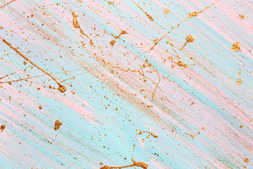 Diagonal pink and blue background with Random gold paint splashes. Place for your design