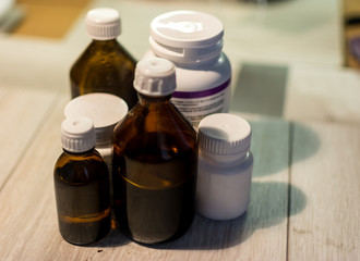 medicine and medical thermometer on white background