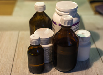 medicine and medical thermometer on white background