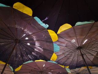 The broken and old umbrella, bright yellow and blue