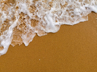 sand and waves on the beach at Pattaya, Thailand