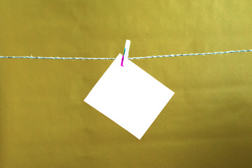 a white sheet of paper hanging on a rope.place for your text, copy space