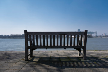 Fototapeta na wymiar Bench seat in the city of rotterdam with river view