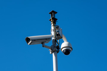 Security camera's outside with blue sky backdrop