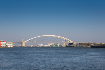 Van Brienenoord Bridge in Rotterdam over the river Nieuwe Maas seen from the north bank on the east side. The two arch bridges, part of the A16 motorway, were completed in 1965 and 1990 respectively.