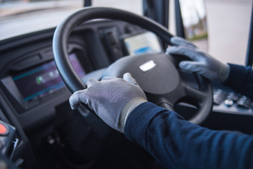 bus driver with protection gloves driving intercity bus