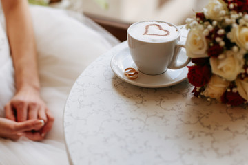 Bride in a stylish ivory dress.  Beautiful manicure. Wedding ring. Space for text