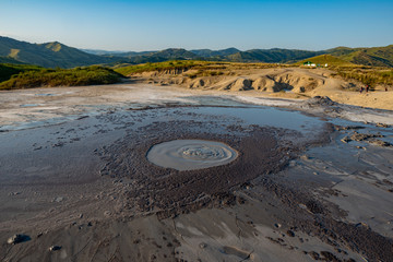 crater of a mud volcano with lava