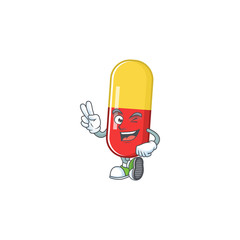 Cheerful red yellow capsules mascot design with two fingers