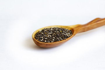 Black Chia seeds in a wooden spoon close-up. Macrophotography of Chia. Health food. Good nutrition....