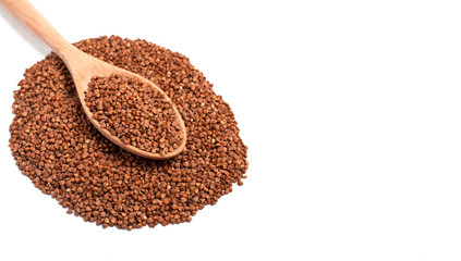 Dry buckwheat on wooden spoon isolated on white background.