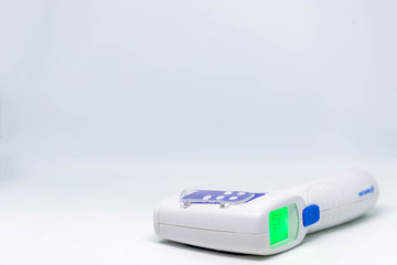 Thermometer gun,Close up infrared forehead thermometer isolate on white background,Spot focus,Copy...