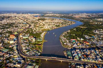 Obraz premium Top view aerial view of Cai Rang bridge, Can Tho City with development buildings, transportation, energy power infrastructure. Financial and business centers in Mekong delta, Vietnam.