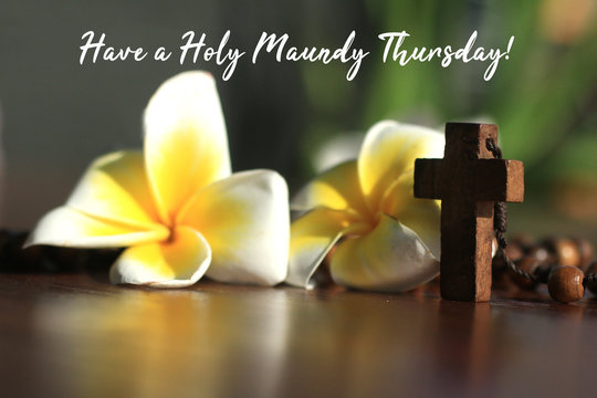Have a Holy Maundy Thursday. Holy week concept. With Jesus Christ holy cross crucifix on wooden rosary beads the Catholic symbol and Bali frangipani flowers. - Powered by Adobe