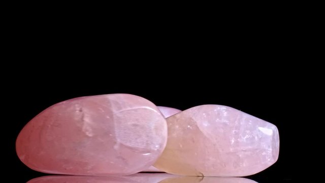 Beautiful uncut rose quartz gemstone,motion black background