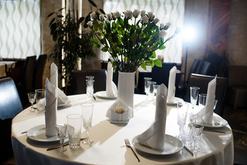 Laid table for guests. All necessary utensils on the table.